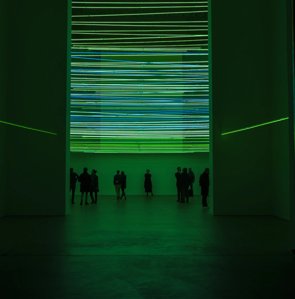 A green coloured light installation in a modern art museum