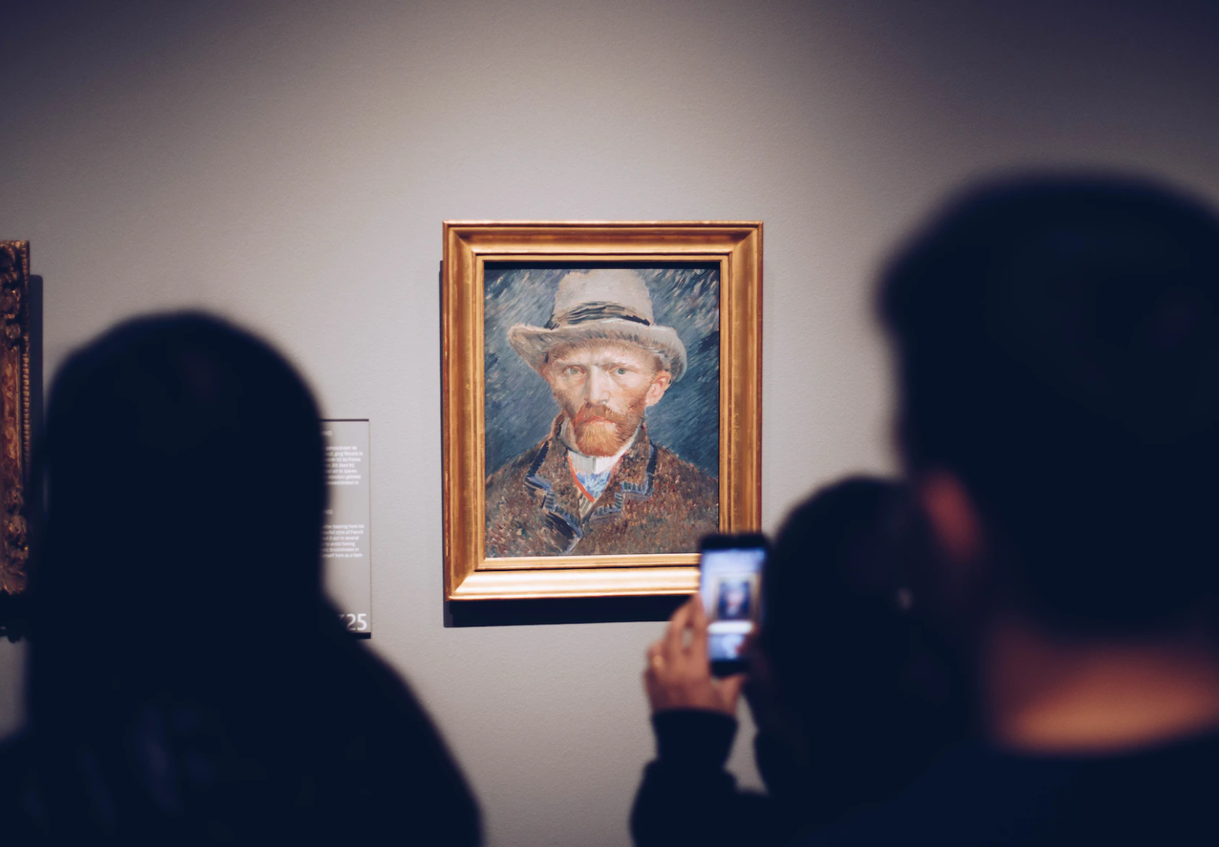 Museum visitors looking at a Van Gogh painting